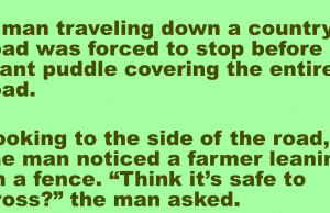 A man stop before a giant puddle